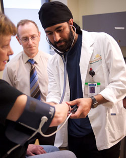 Resident helping patient